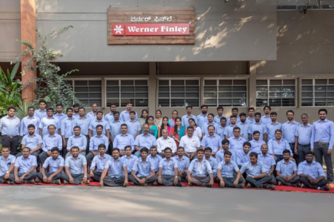 Picture of the Werner Finley Building in Bangalore, India. All employees seen in front of the building.