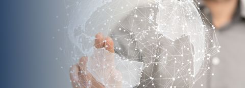 A man stretches out his arm and points with his index finger to a networked globe graphic in the foreground.